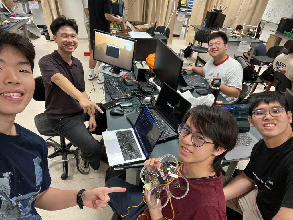 Justin Yu and Group 22 teammates presenting the completed DreamCatcher quadcopter with circular propeller guards at the NTU makerspace