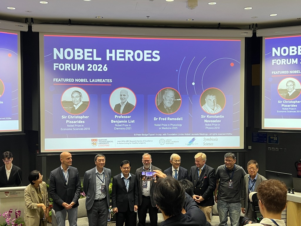 Group photograph on stage of the four Nobel Laureates with university leadership at the Nobel Heroes Forum 2026.