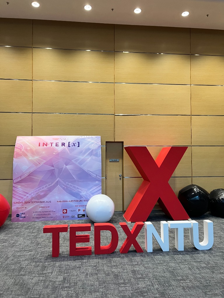 The large red X installation and TEDxNTU signage at the Nanyang Auditorium foyer.