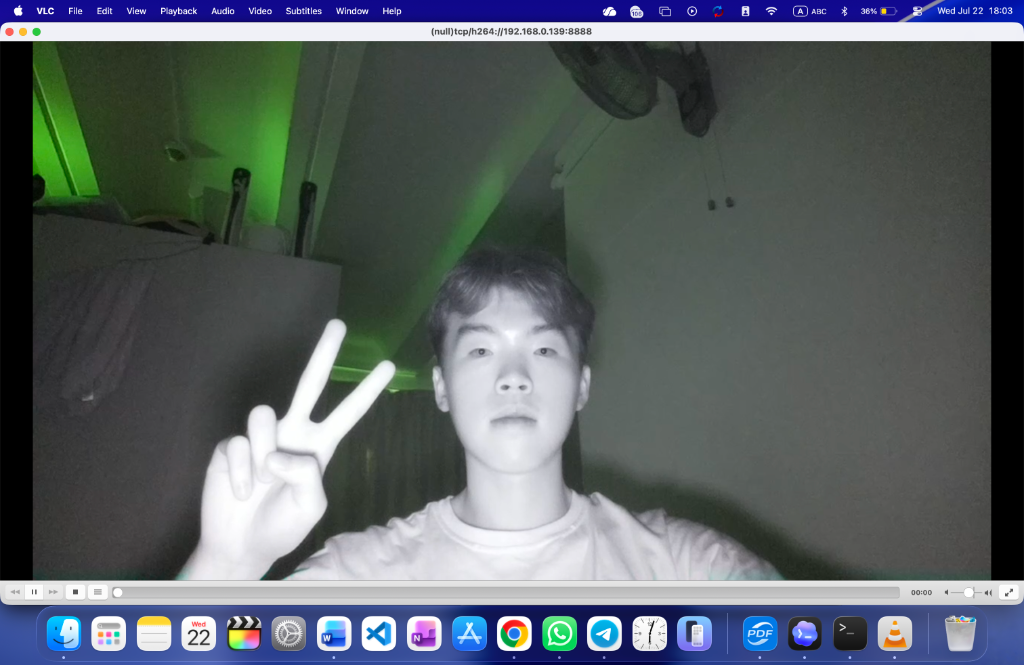 VLC player streaming TCP H.264 video at 192.168.0.139 with 940nm infrared illumination showing Justin Yu giving a peace sign in the dark.